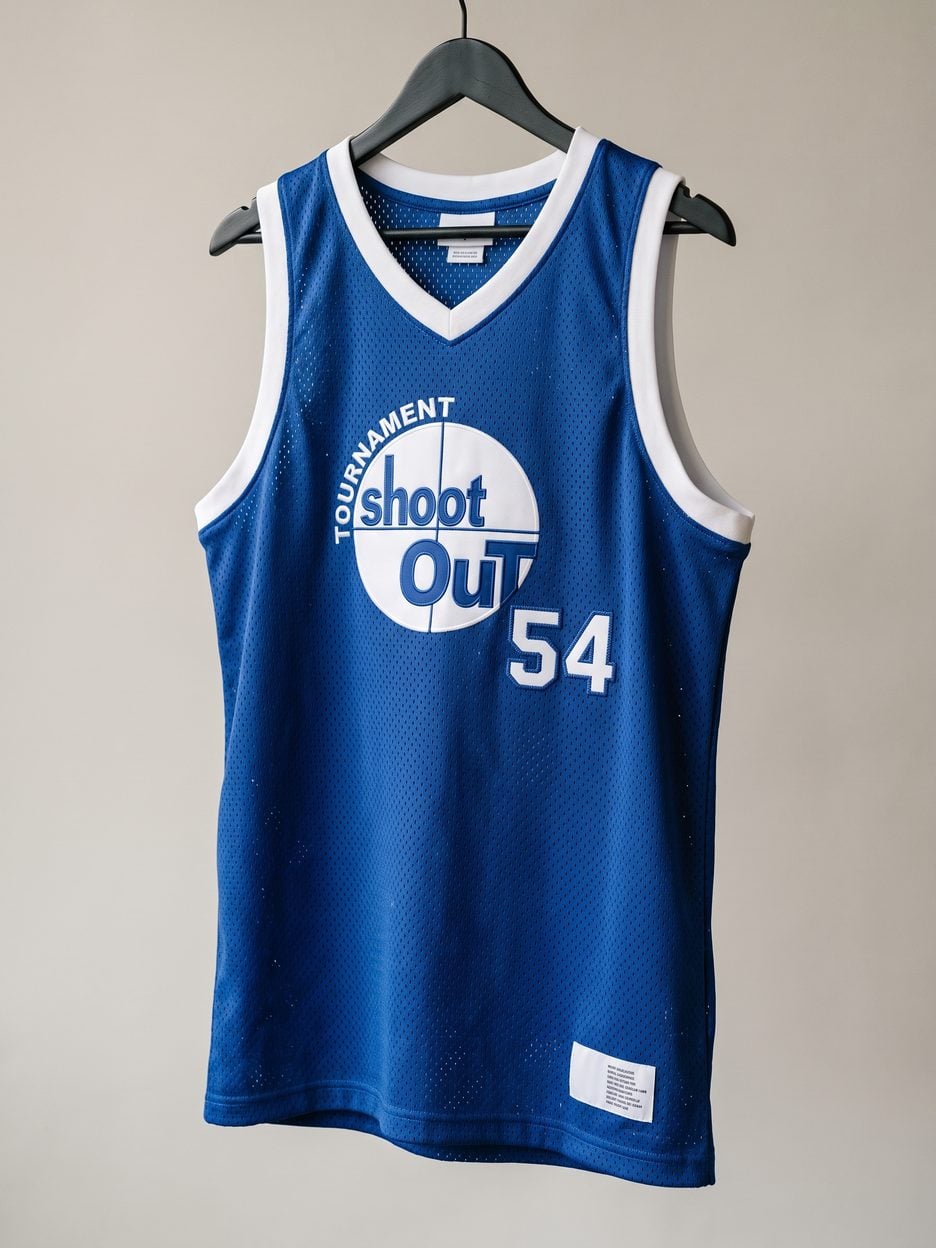 This jersey on a hanger, close enough to see the stitching, the fabric and the tags