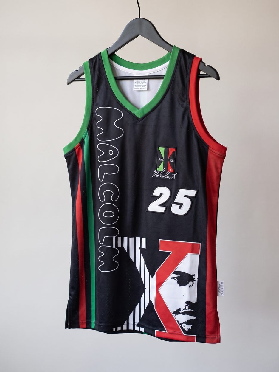 This jersey on a hanger, close enough to see the stitching, the fabric and the tags