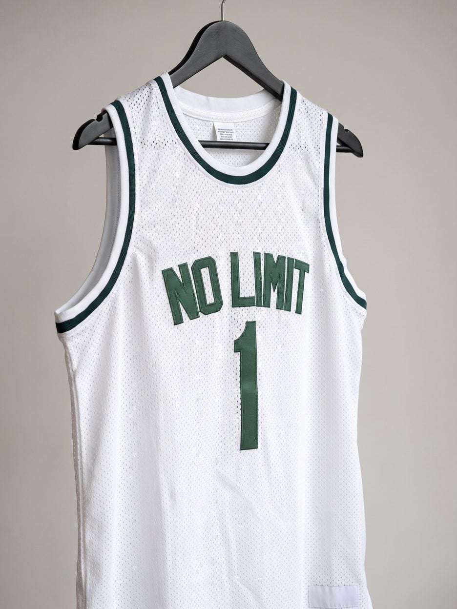 This jersey on a hanger, close enough to see the stitching, the fabric and the tags