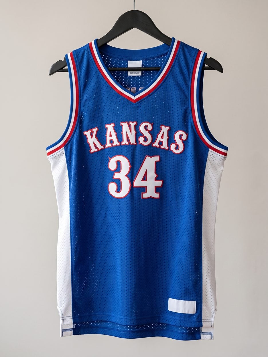 This jersey on a hanger, close enough to see the stitching, the fabric and the tags